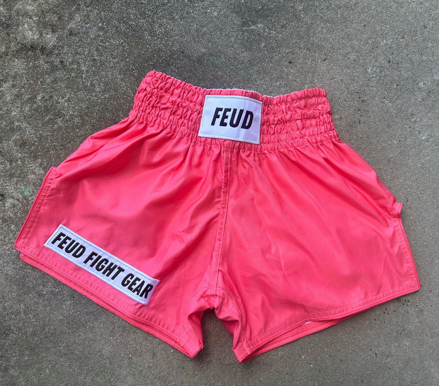 Muay Thai shorts for men and women. Coral pink in colour. Custom thai shorts are available for personalised with your name.