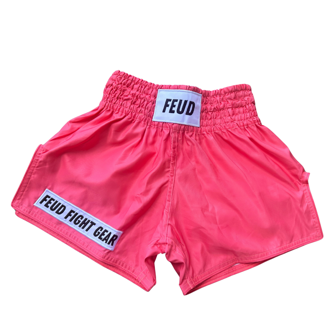 Muay Thai shorts for men and women. Coral pink in colour. Custom thai shorts are available for personalised with your name.