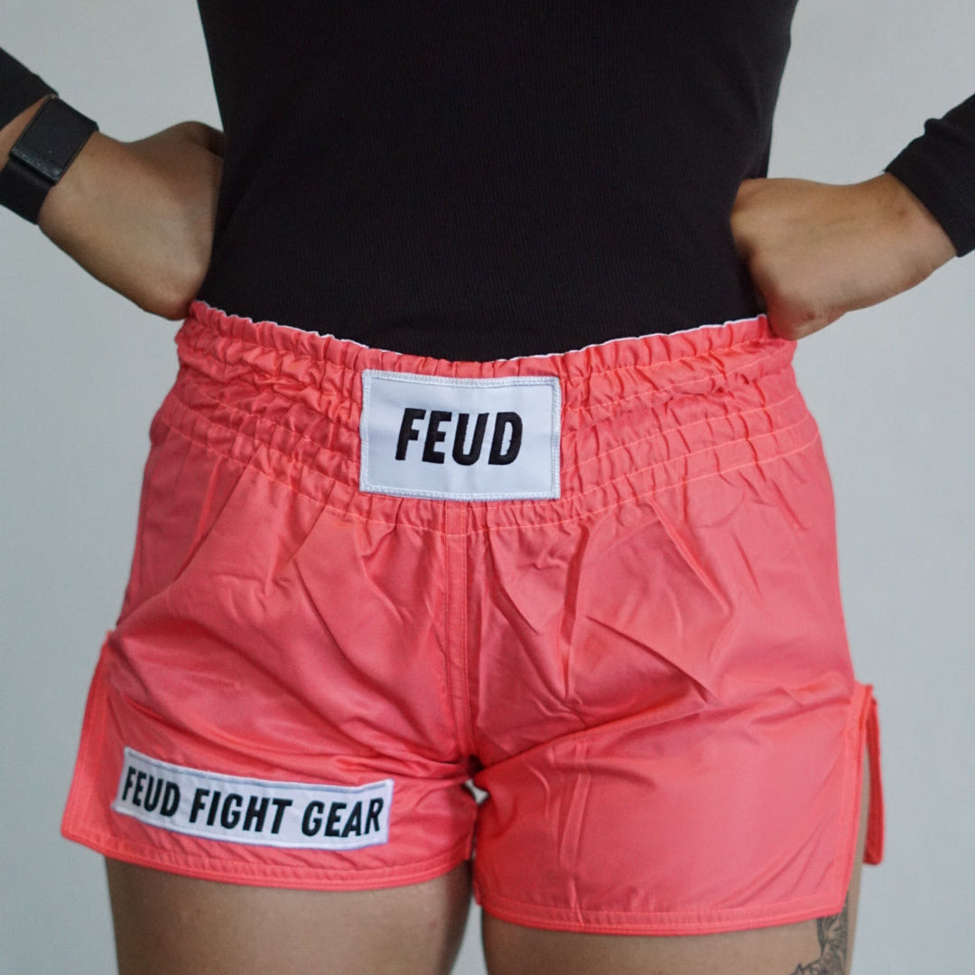 Muay Thai shorts for men and women. Coral pink in colour. Custom thai shorts are available for personalised with your name.