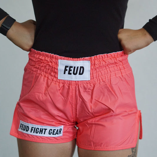 Muay Thai shorts for men and women. Coral pink in colour. Custom thai shorts are available for personalised with your name.