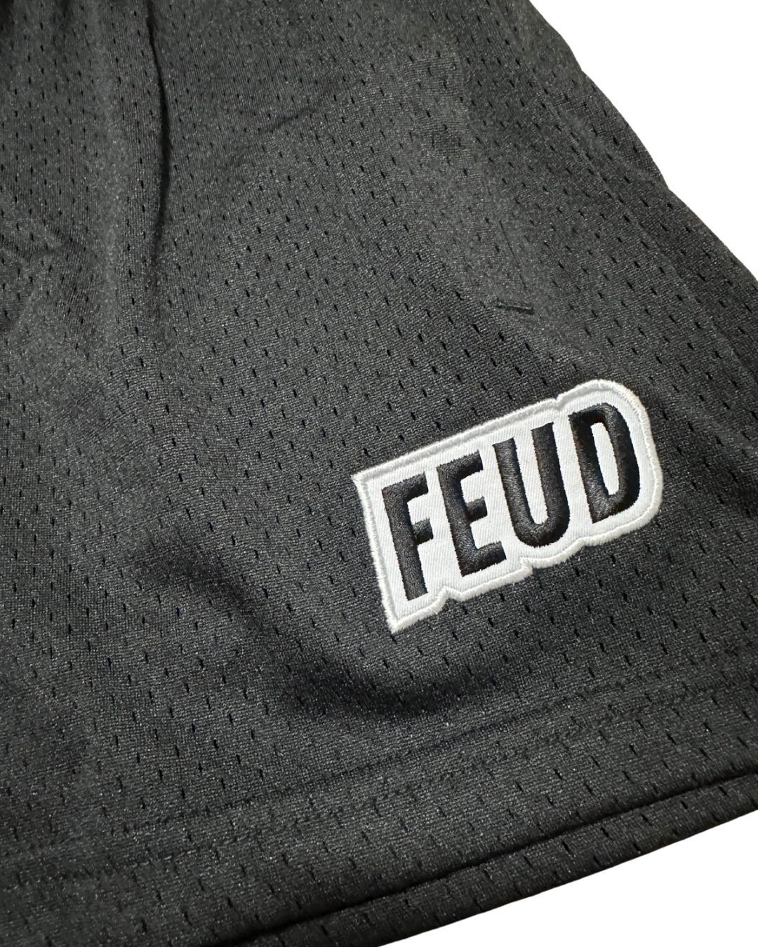 Close-up Feud logo on black shorts