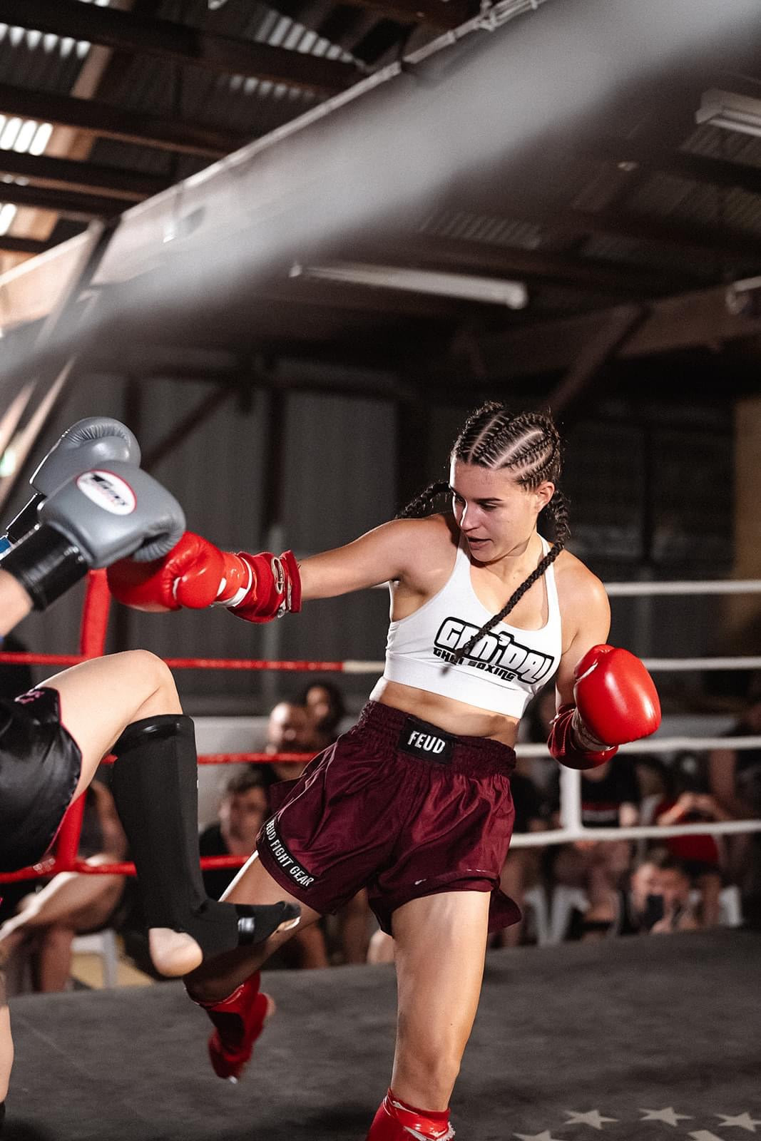 Woman in Burgundy Thai Shorts by Feud Fight Gear