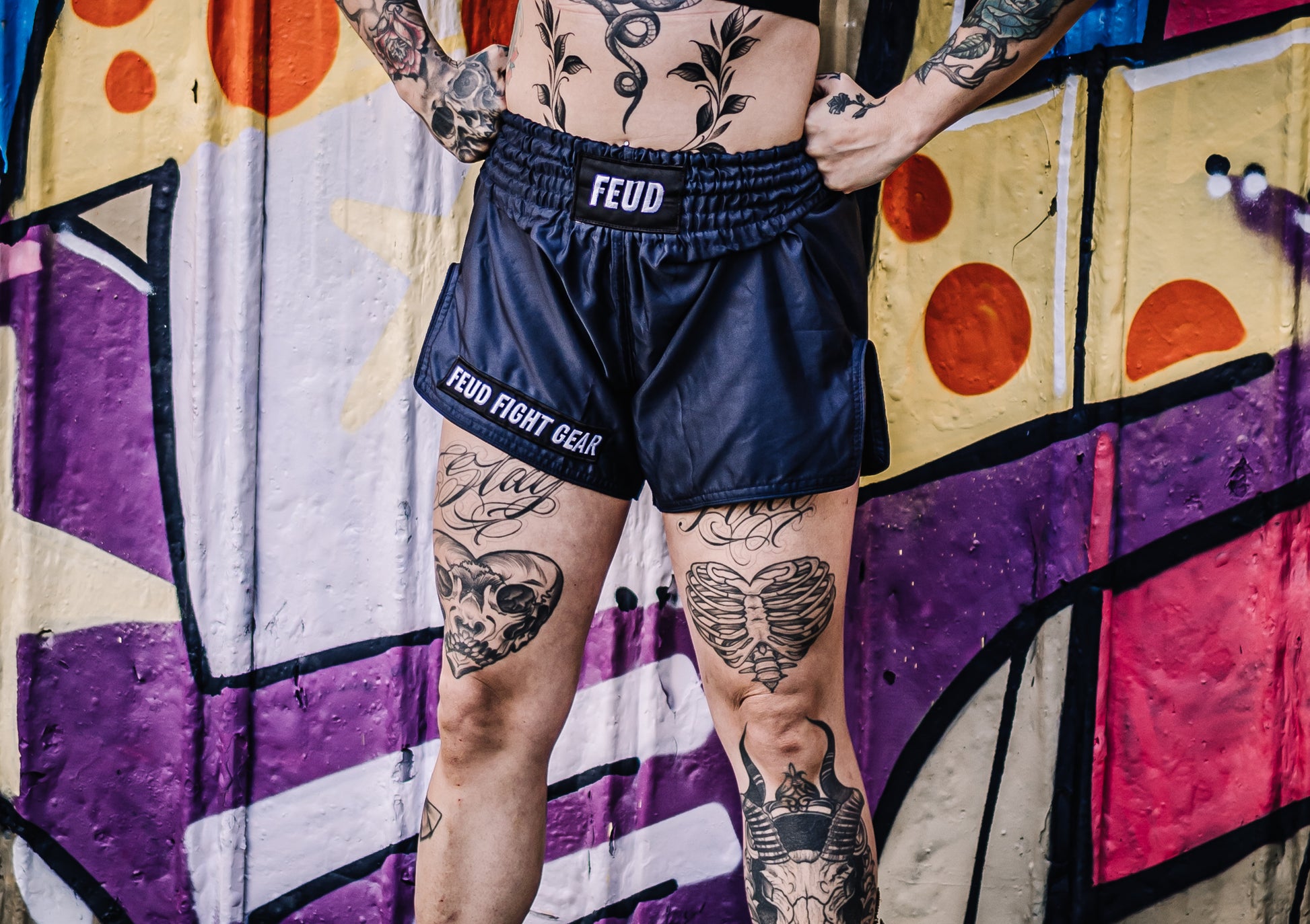 Tattooed woman wearing Navy Blue Thai Shorts