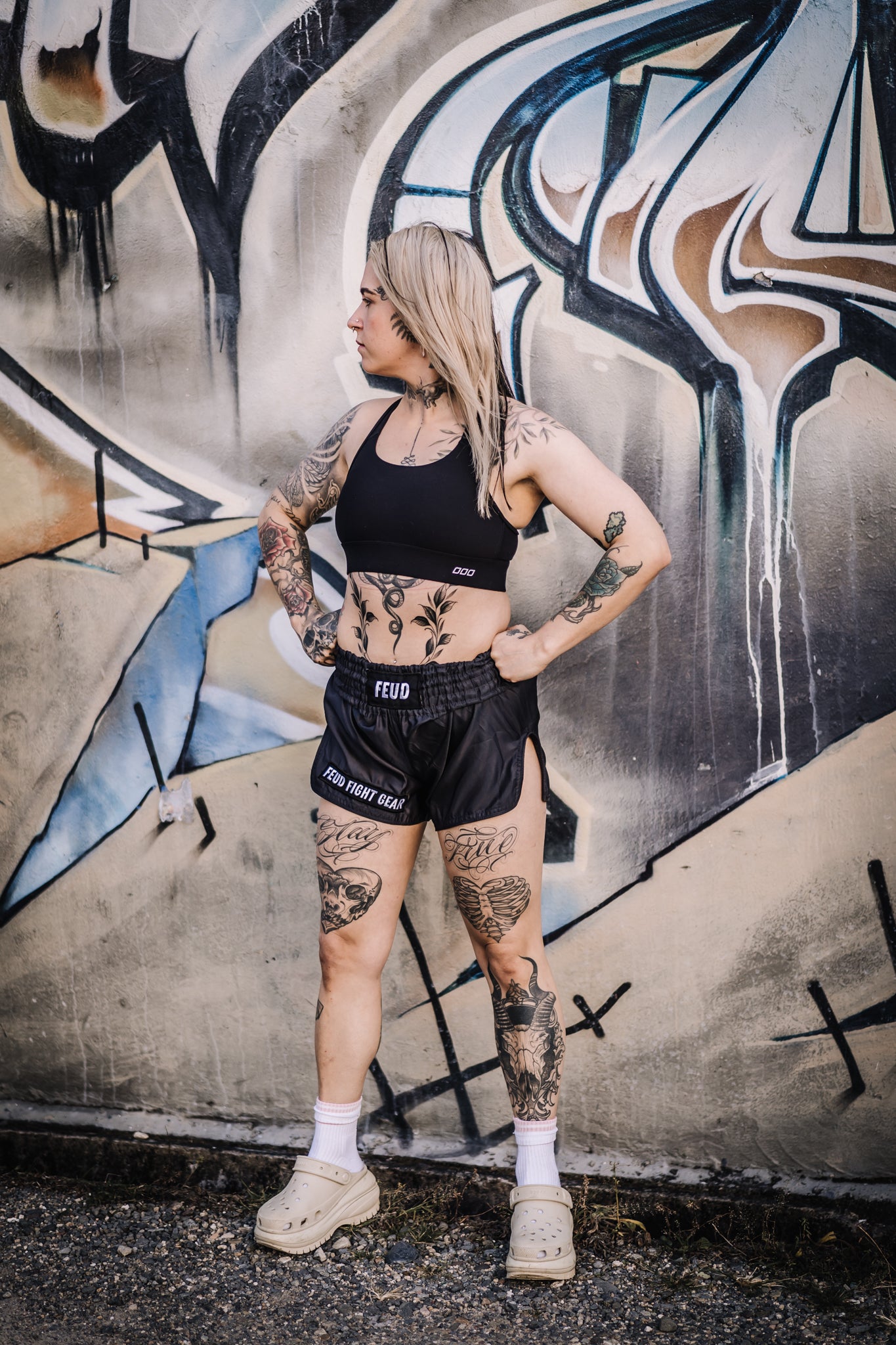Tattooed woman posing outdoors in Gunmetal Grey Thai Shorts