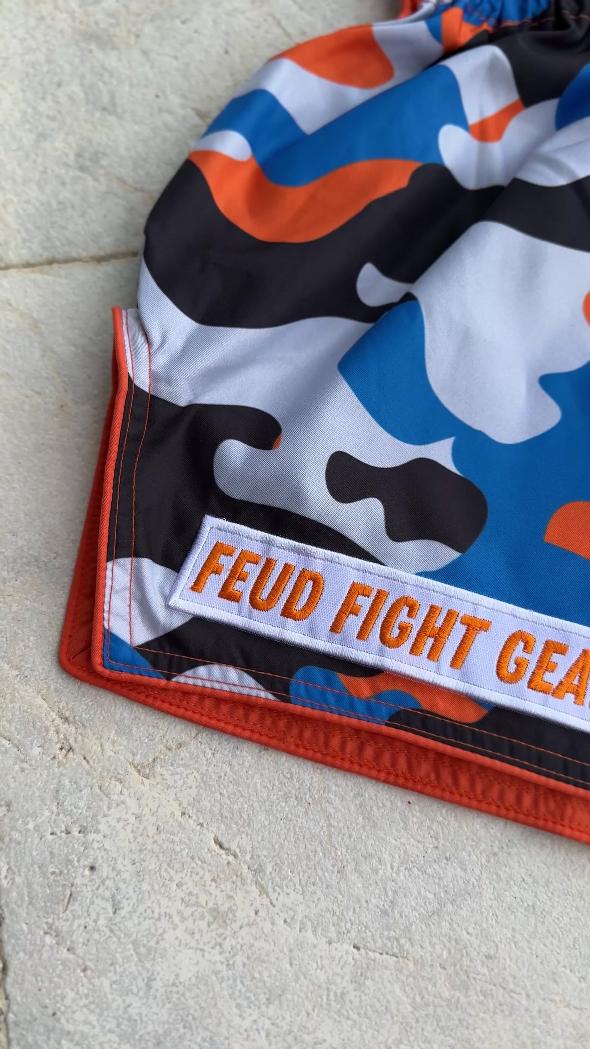 Video of Orange Blue Camo Thai Shorts front and back view