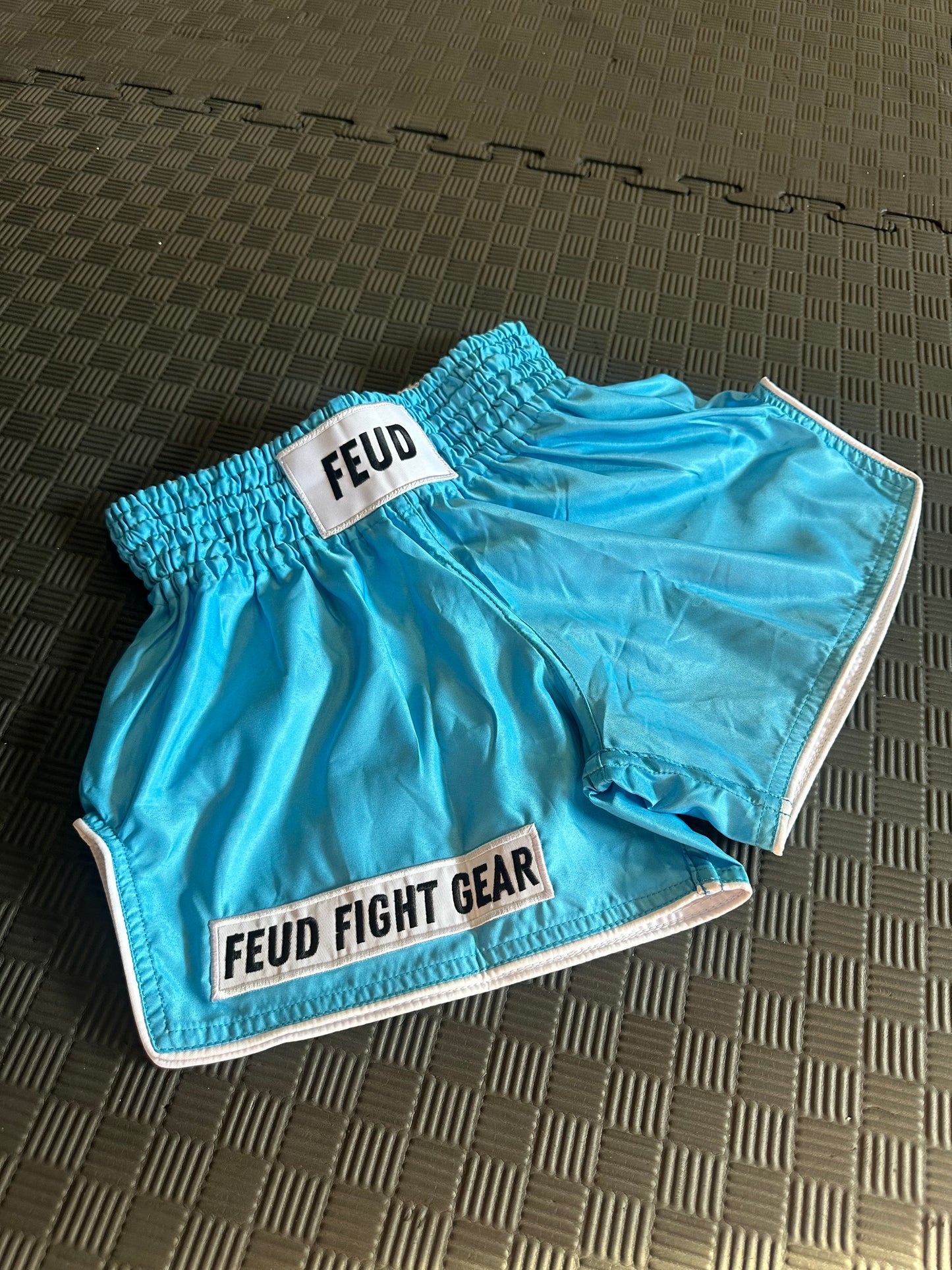 Blue Ocean Muay Thai shorts on the gym mats. 